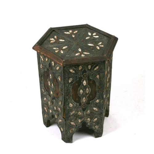 668 - An Islamic occasional table of hexagonal form with metal and bone overlaid decoration, 38cms diamete... 