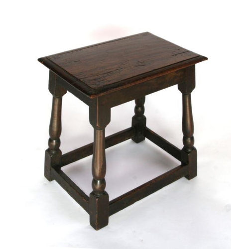 690 - An oak joint stool on turned legs joined by stretchers, 46cms wide.