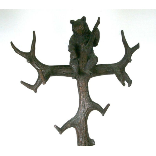 698 - A 20th century Black Forest carved bear hallstand, the adult bear climbing the tree and looking up a... 