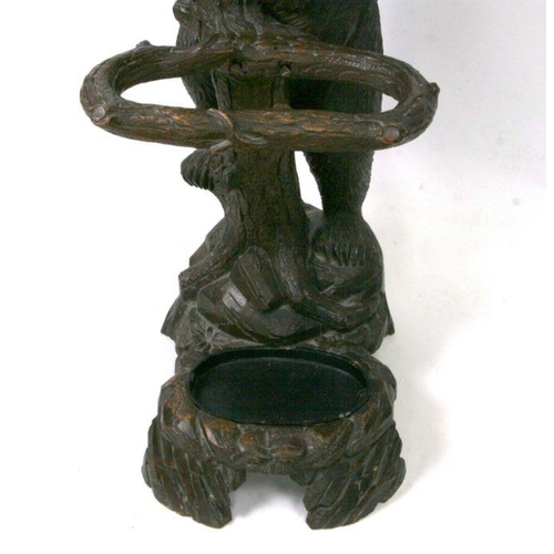 698 - A 20th century Black Forest carved bear hallstand, the adult bear climbing the tree and looking up a... 