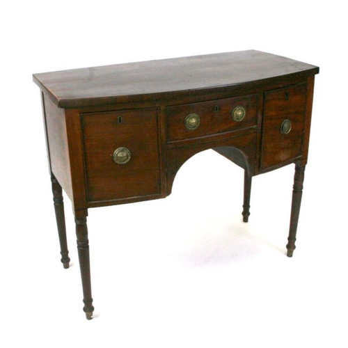 699 - A Regency mahogany bowfronted sideboard with central frieze drawer flanked by cupboards, on ring tur... 