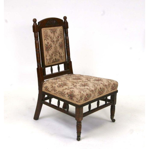 706 - A Godwin design style walnut nursing chair with upholstered seat and back.