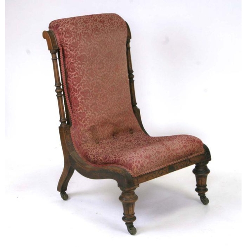 710 - A 19th century upholstered walnut nursing chair on turned front supports.