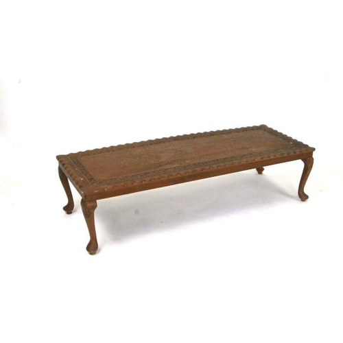 713 - An Asian hardwood coffee table with pierced foliate decoration, on cabriole legs, 123cms wide.