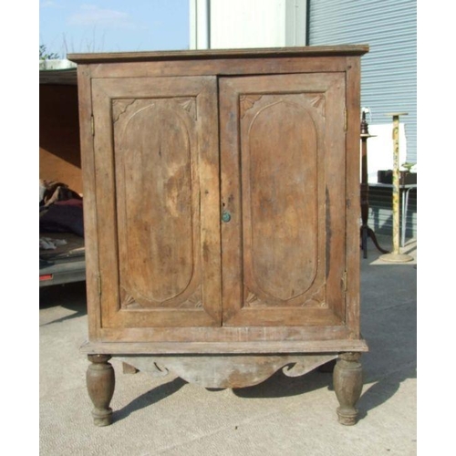 769 - A large Asian hardwood two door cupboard on turned front legs