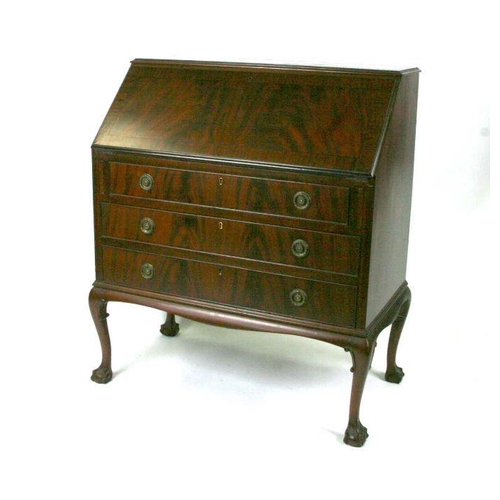 784 - An Edwardian figured mahogany bureau, the fall-flap enclosing a fitted interior above three graduate... 