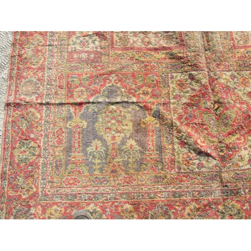 91 - A Turkish carpet with central floral medallion on a red ground, 202 by 286cms.