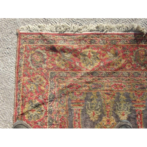 91 - A Turkish carpet with central floral medallion on a red ground, 202 by 286cms.