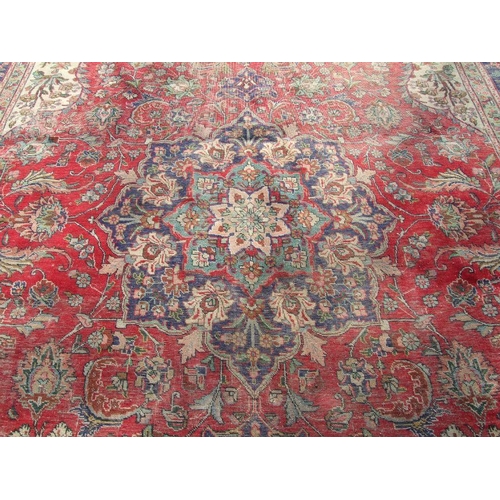 92 - A Persian rug with foliate design on a blue ground 304 by 377cms.