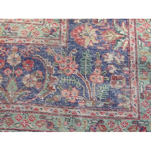 92 - A Persian rug with foliate design on a blue ground 304 by 377cms.