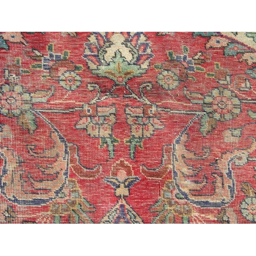 92 - A Persian rug with foliate design on a blue ground 304 by 377cms.