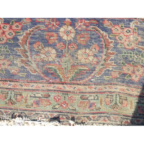 92 - A Persian rug with foliate design on a blue ground 304 by 377cms.