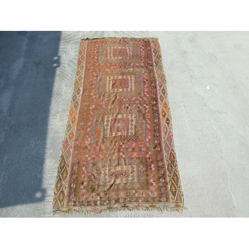 94 - A kilim rug with repeating geometric motifs on a mustard ground within a multi border, 152 by 317cms... 