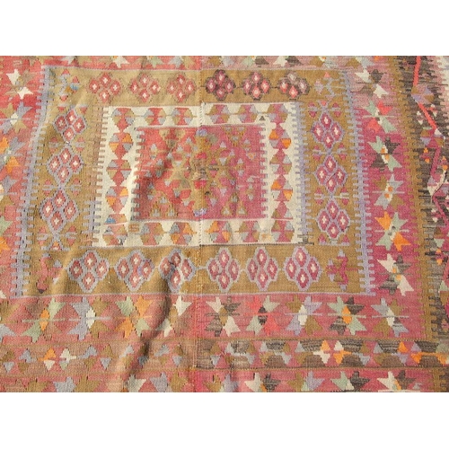 94 - A kilim rug with repeating geometric motifs on a mustard ground within a multi border, 152 by 317cms... 