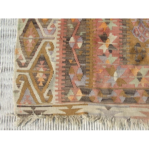 94 - A kilim rug with repeating geometric motifs on a mustard ground within a multi border, 152 by 317cms... 