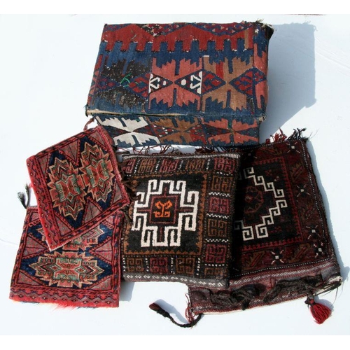 95 - A Turkish or Bedouin camel bag; together with two similar smaller bags; a cushion and a pine box lat... 