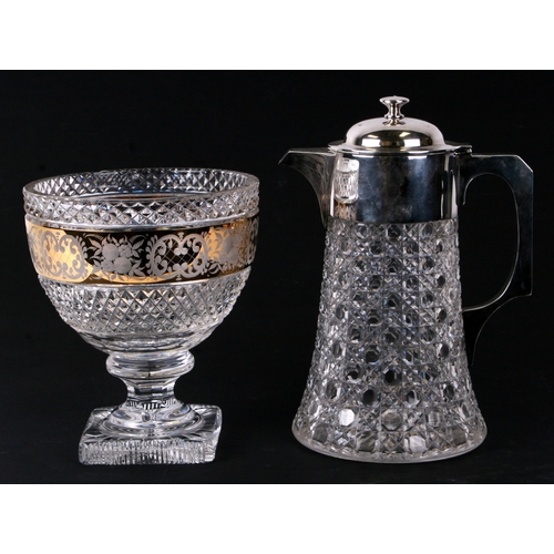 233 - A cut glass water jug with silver plated mounts, 26cms high; together with a glass pedestal bowl wit... 