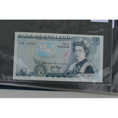 429 - An album containing English banknotes to include 10 shilling note, £1 notes and £5 notes, some in un... 