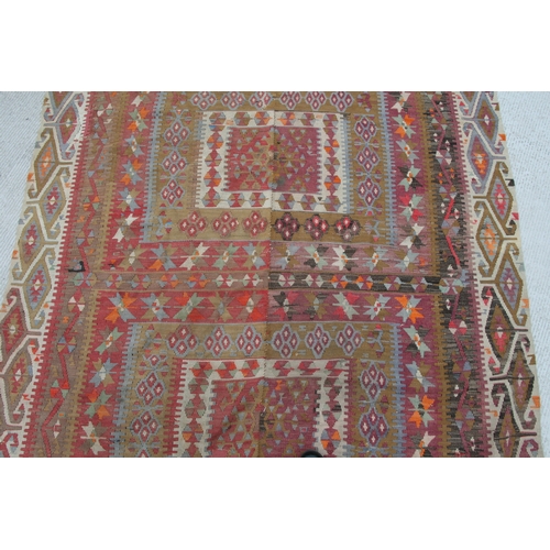 94 - A kilim rug with repeating geometric motifs on a mustard ground within a multi border, 152 by 317cms... 