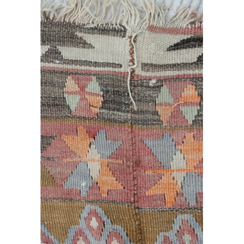 94 - A kilim rug with repeating geometric motifs on a mustard ground within a multi border, 152 by 317cms... 