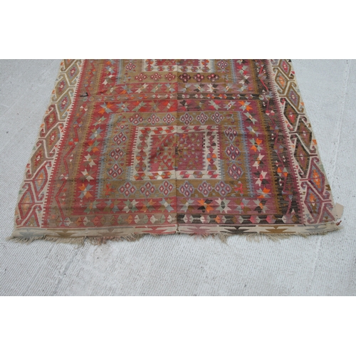 94 - A kilim rug with repeating geometric motifs on a mustard ground within a multi border, 152 by 317cms... 