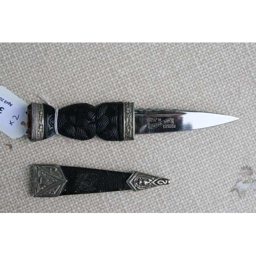 36 - A Scottish Sgian Dubh, the blade signed 'J Nowill & Sons Ltd, in a leather scabbard, 20cms long;... 