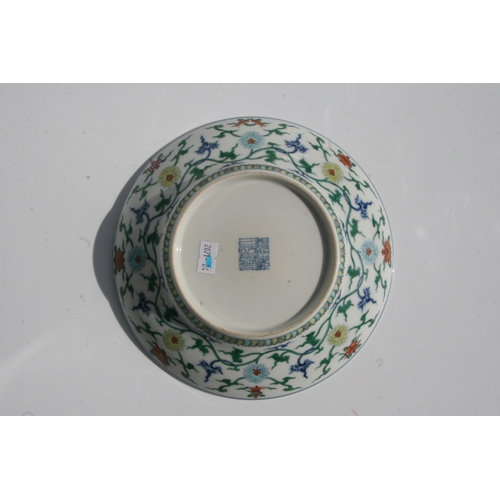 528 - A Chinese Ducai style bowl of shallow flared form decorated with scrolling flowers and foliage, blue... 