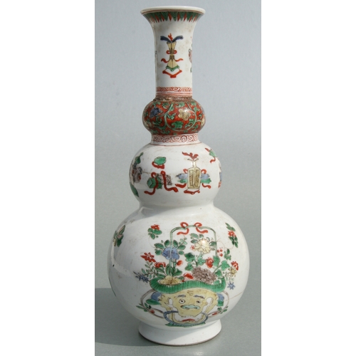 617 - A Chinese Kangxi famille rose triple gourd vase decorated with precious objects, 26cms high.