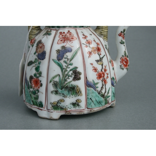 618 - A Chinese famille rose teapot decorated with flowers and insects, 17cms high.