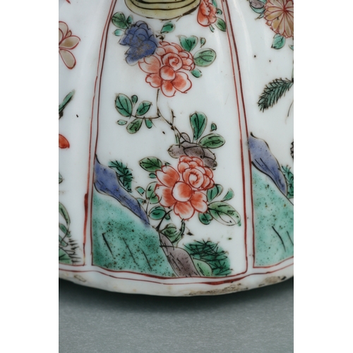 618 - A Chinese famille rose teapot decorated with flowers and insects, 17cms high.