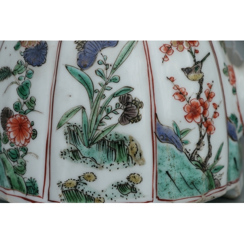 618 - A Chinese famille rose teapot decorated with flowers and insects, 17cms high.