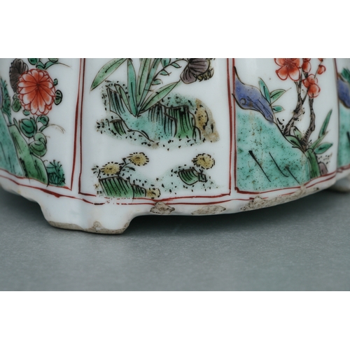 618 - A Chinese famille rose teapot decorated with flowers and insects, 17cms high.