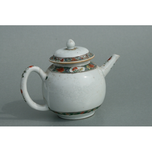 619 - A Chinese famille rose teapot of globular form, decorated with sgraffito and flowers, 11cms high.