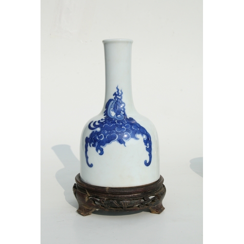 637 - A Chinese blue & white vase of mallet form, six character blue mark to the underside, on a hardwood ... 