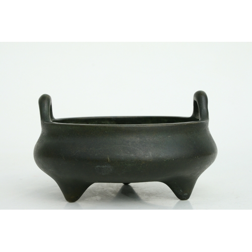 640 - A Chinese bronze two-handled censer on tripod legs, six character mark to the underside, 16cms diame... 