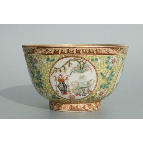 641 - A Chinese famille rose bowl decorated with precious objects within roundels with foliate scrolls on ... 