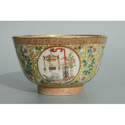 641 - A Chinese famille rose bowl decorated with precious objects within roundels with foliate scrolls on ... 