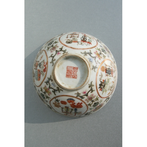 642 - A Chinese famille rose bowl decorated with precious objects within roundels and foliate scrolls, red... 