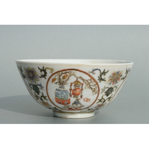 642 - A Chinese famille rose bowl decorated with precious objects within roundels and foliate scrolls, red... 