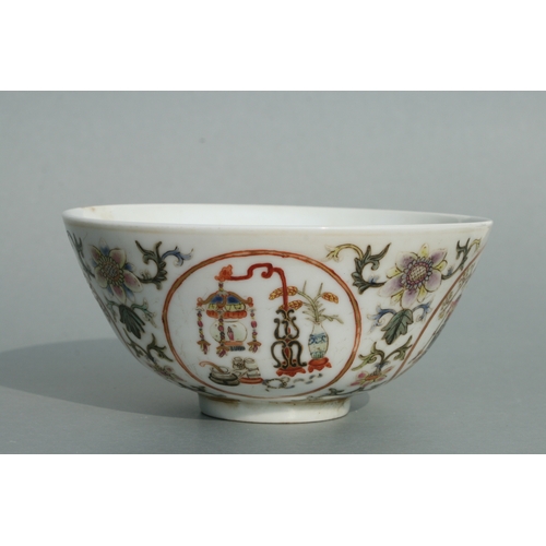 642 - A Chinese famille rose bowl decorated with precious objects within roundels and foliate scrolls, red... 