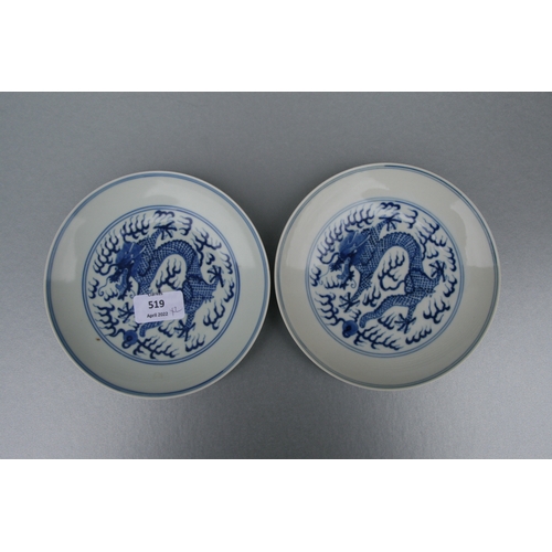 519 - A pair of Chinese blue & white shallow dishes decorated with dragons chasing a flaming pearl amongst... 