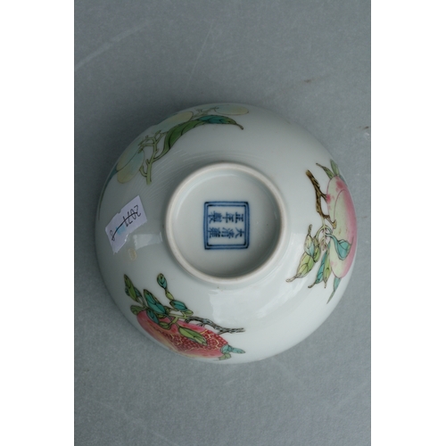 515 - A Chinese footed bowl decorated with fruit to include peaches and pomegranates, six character blue m... 