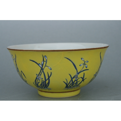 516 - A Chinese footed bowl decorated with flowers on an Imperial yellow ground, four character red mark t... 