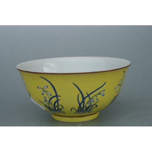 516 - A Chinese footed bowl decorated with flowers on an Imperial yellow ground, four character red mark t... 