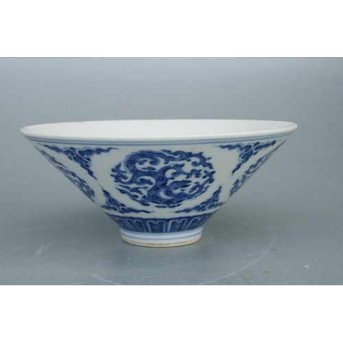 517 - A Chinese blue & white bowl decorated with stylised dragons, six character blue mark to the undersid... 