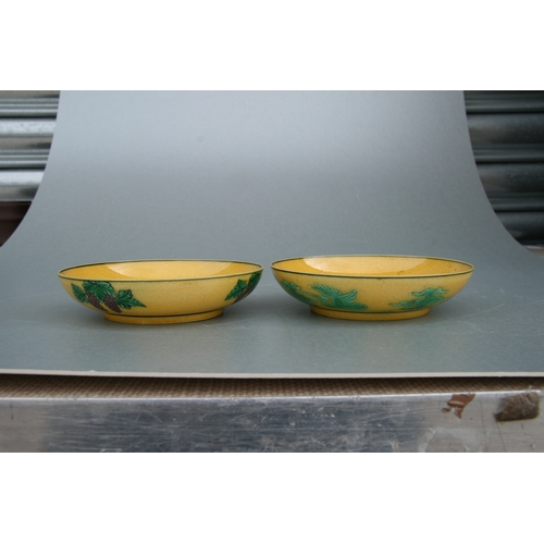 523 - A pair of Chinese shallow bowls, each decorated with dragons chasing a flaming pearl amongst clouds ... 