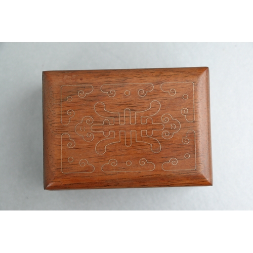 556 - A Chinese hardwood rectangular box and cover (possibly huanghuali), the cover with inlaid decoration... 