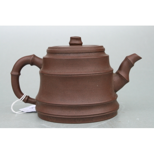 583 - A Chinese Yixing pottery teapot with stylised bamboo spout and handle, impressed seal mark to the un... 