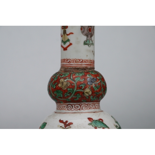 617 - A Chinese Kangxi famille rose triple gourd vase decorated with precious objects, 26cms high.