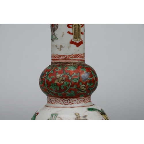 617 - A Chinese Kangxi famille rose triple gourd vase decorated with precious objects, 26cms high.